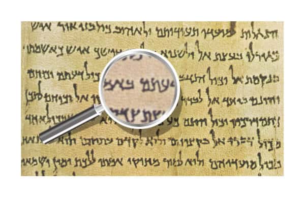 The Community Rule Dead Sea Scroll Text first page snippet with a magnifying glass in front